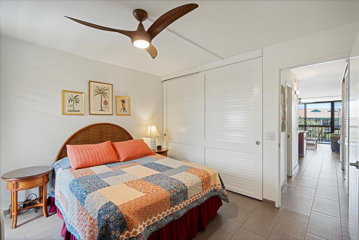 2191 South Kihei Road, Unit 2303 Kihei, HI 96753 - Photo 37 of 43 a bedroom with a bed and a painting on the wall