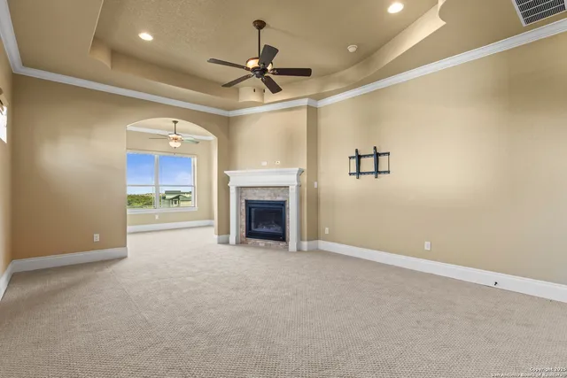 an empty room with a window and a fan