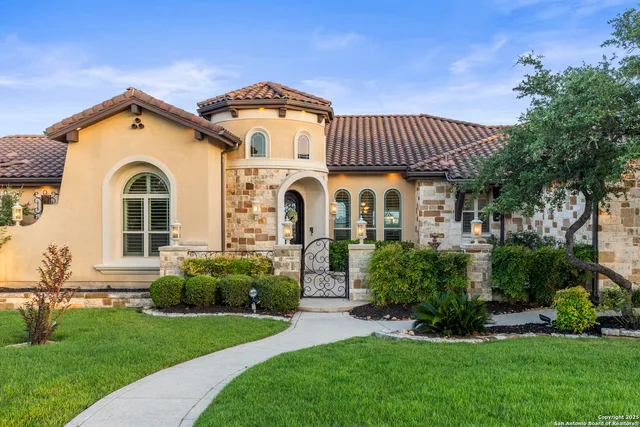 a view of a brick house with potted plants