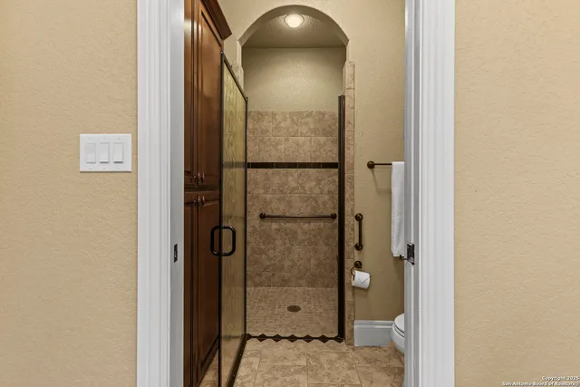 an aerial view of residential houses with city view and tree