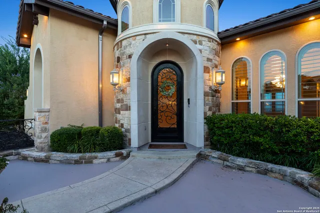 a view of a white house with a yard and sitting area