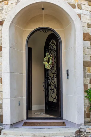 an empty room with wooden floor fireplace and windows