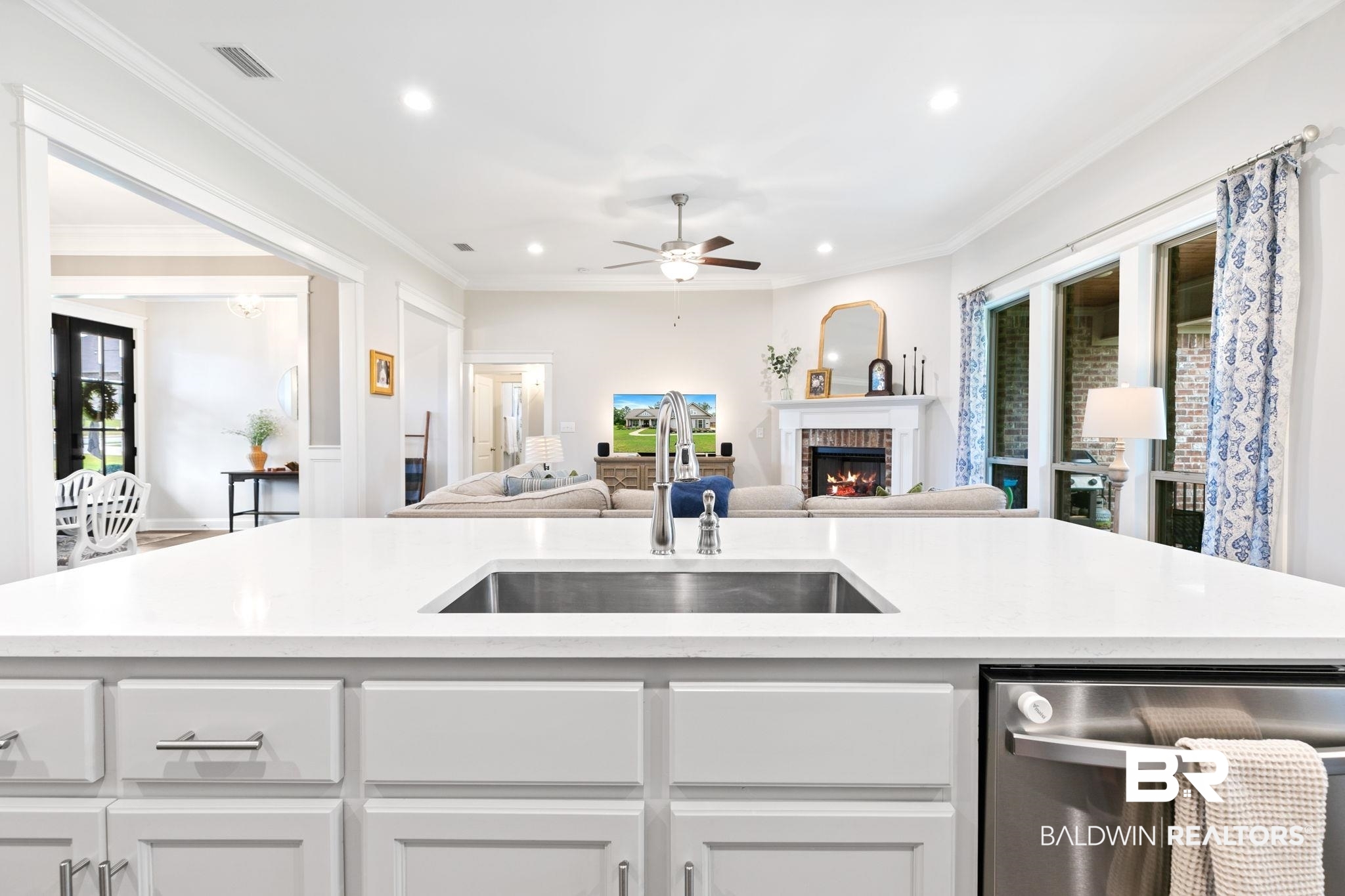 13233 Ibis Boulevard Daphne, AL 36527 - Photo 15 of 100 Spacious kitchen island featuring a stainless steel sink, white cabinetry, and a stainless steel dishwasher