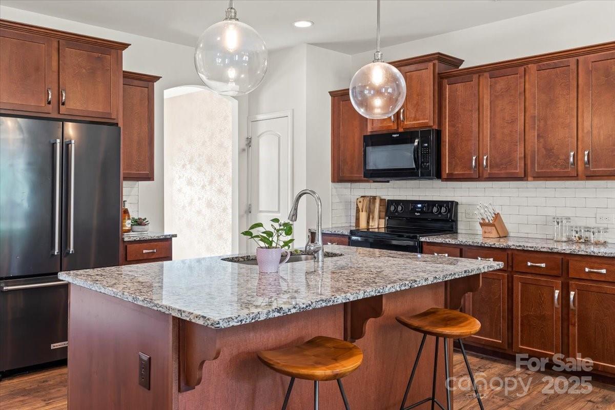 3019 Riker Street Clover, SC 29710 - Photo 8 of 43 a kitchen with granite countertop kitchen island a table and chairs in it