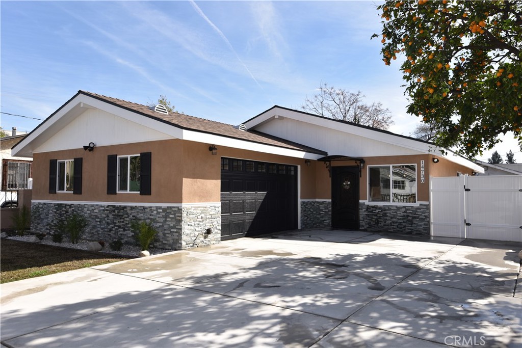 14730 Clark Street Baldwin Park, CA 91706 - Photo 1 of 5 a front view of a house with a yard and garage