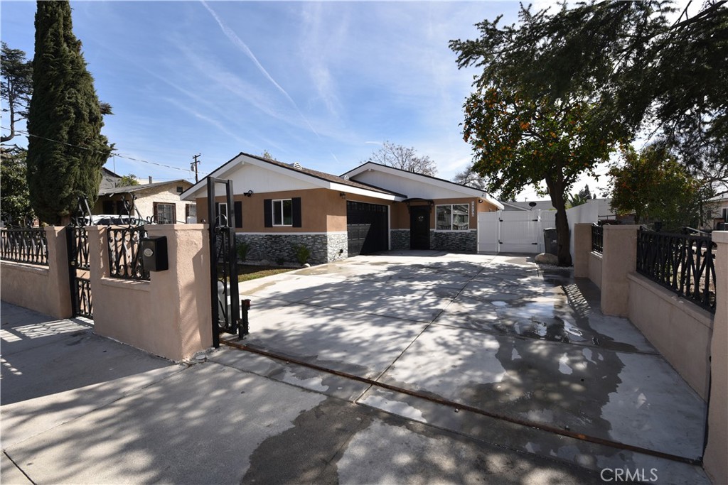 14730 Clark Street Baldwin Park, CA 91706 - Photo 2 of 5 a front view of a house with a yard covered with trees