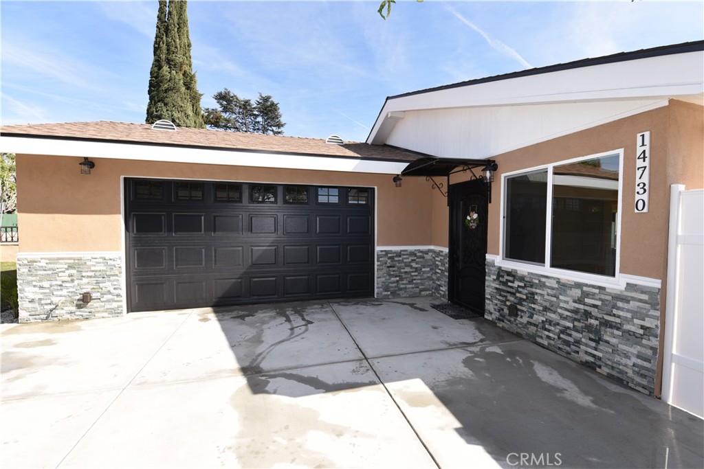 14730 Clark Street Baldwin Park, CA 91706 - Photo 4 of 5 a front view of a house with a garage