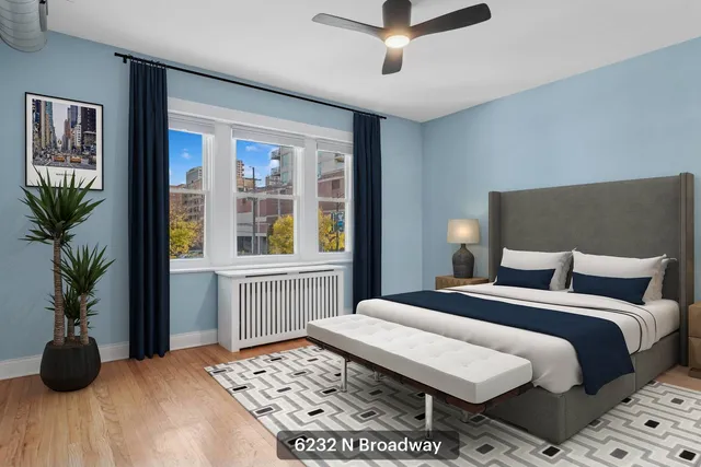 a bedroom with a large bed and a potted plant