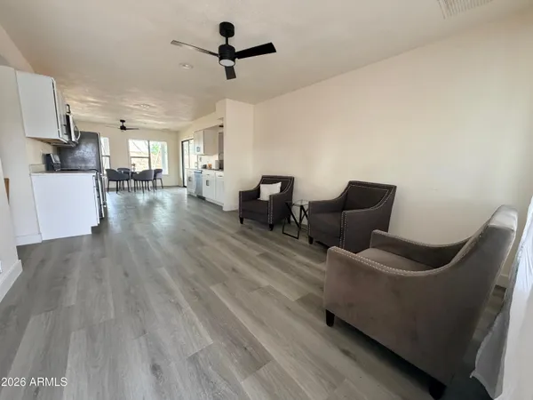 a kitchen with white cabinets a sink dishwasher and a stove with wooden floor