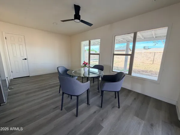 a view of a yard in front of a house with a large tree