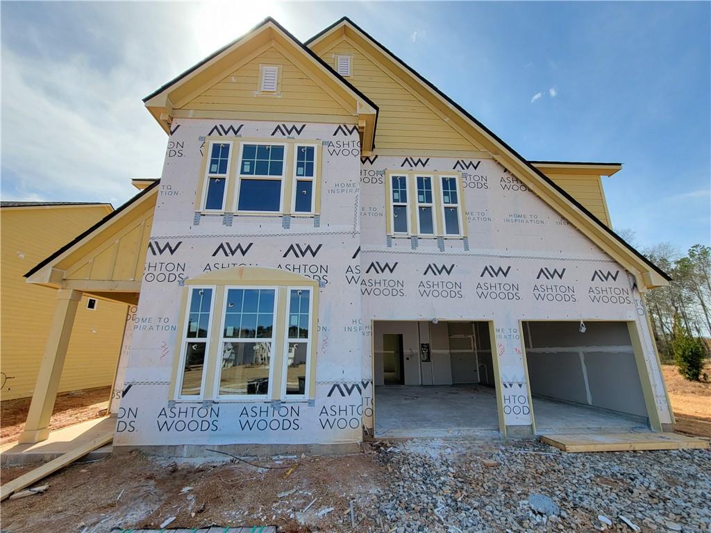a front view of a house with glass windows and garage