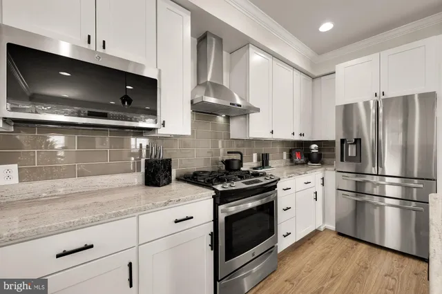 a bedroom with a bed couch and window