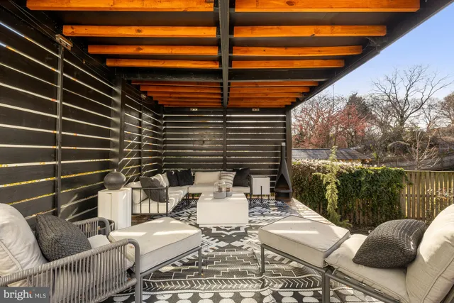 a roof deck with table and chairs and wooden floor