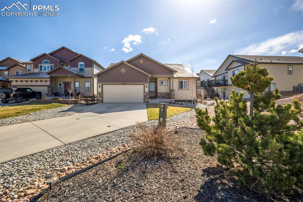17835 Mining Way Monument, CO 80132 - Photo 2 of 49 a front view of a house with a yard and a garage