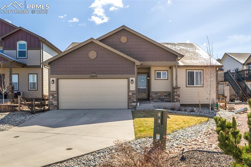 17835 Mining Way Monument, CO 80132 - Photo 3 of 49 a front view of a house with swimming pool having outdoor seating