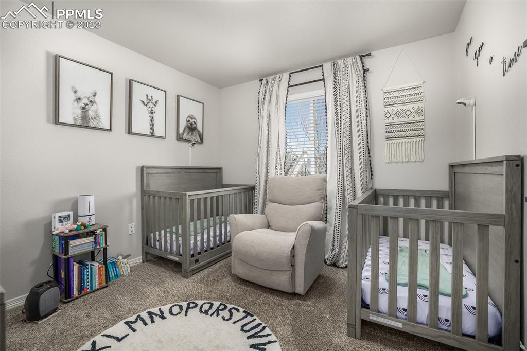 17835 Mining Way Monument, CO 80132 - Photo 31 of 49 a bedroom with furniture and a bed