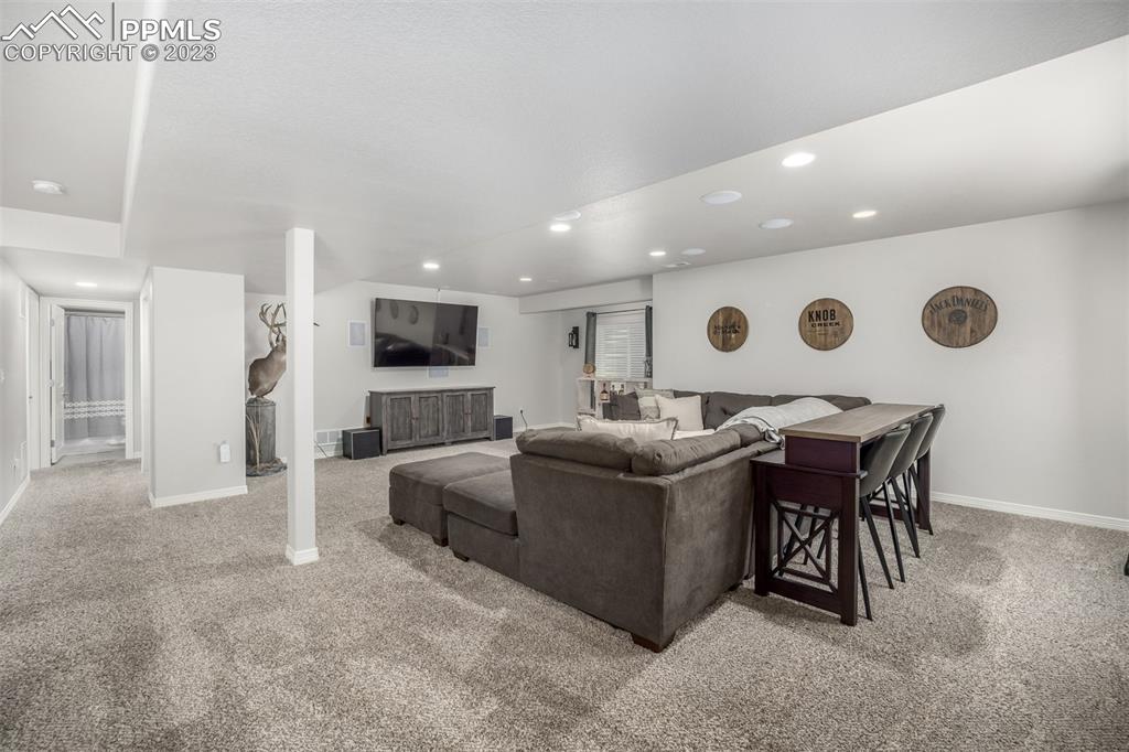 17835 Mining Way Monument, CO 80132 - Photo 37 of 49 a living room with furniture and a flat screen tv