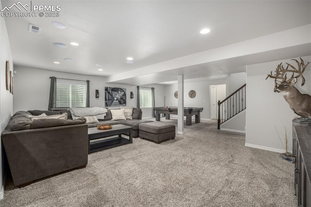 17835 Mining Way Monument, CO 80132 - Photo 40 of 49 a living room with furniture and a flat screen tv