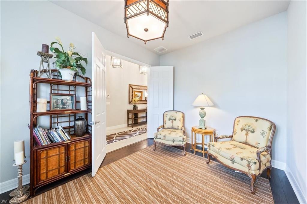13576 Mandarin Circle Naples, FL 34109 - Photo 13 of 24 a bedroom with furniture and a wooden floor
