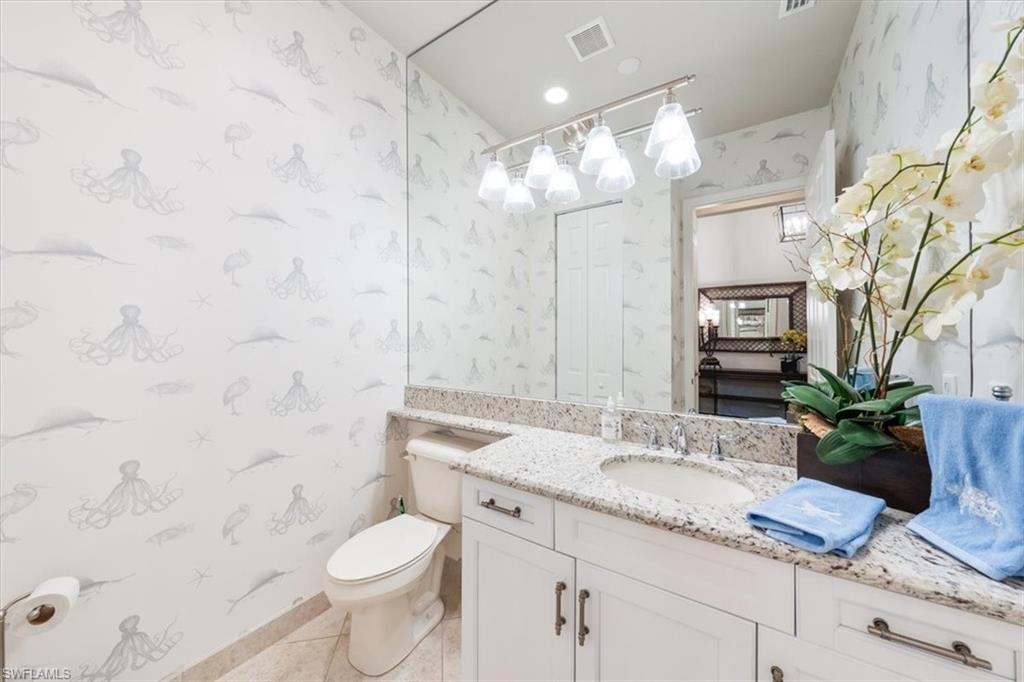 13576 Mandarin Circle Naples, FL 34109 - Photo 15 of 24 a bathroom with a granite countertop sink a toilet and shower