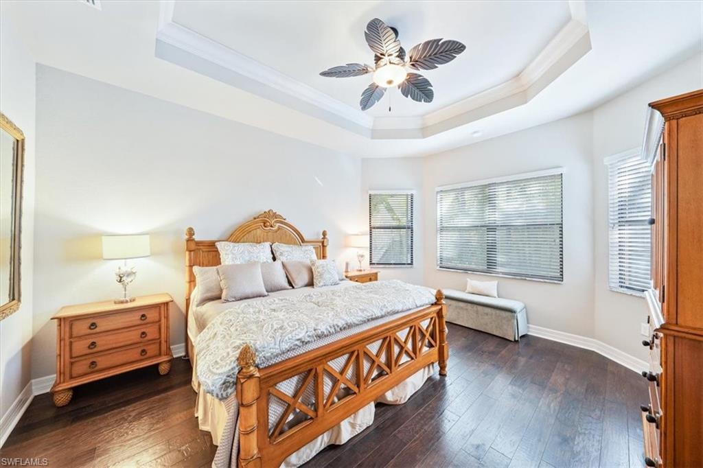 13576 Mandarin Circle Naples, FL 34109 - Photo 16 of 24 a bedroom with a bed and a large window with wooden floor