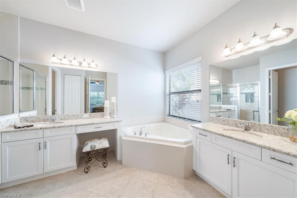 13576 Mandarin Circle Naples, FL 34109 - Photo 17 of 24 a bathroom with a granite countertop sink mirror bathtub and toilet