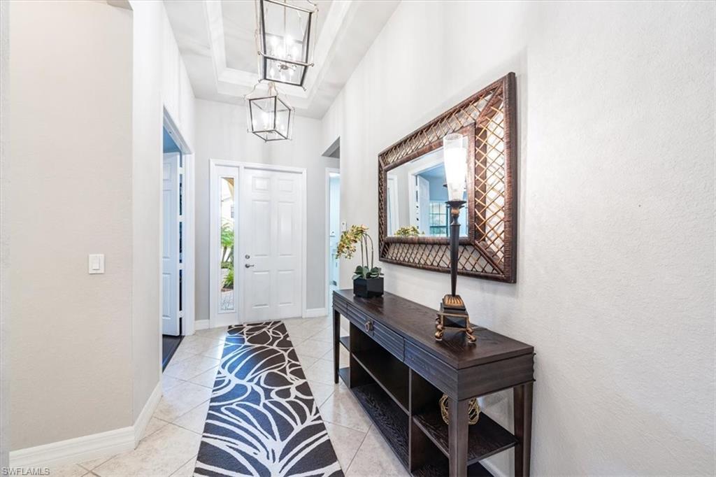13576 Mandarin Circle Naples, FL 34109 - Photo 2 of 24 a living room with a couch a rug and a window