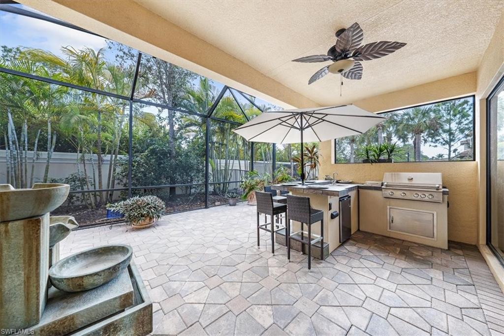13576 Mandarin Circle Naples, FL 34109 - Photo 22 of 24 a view of a patio with a dining table and chairs