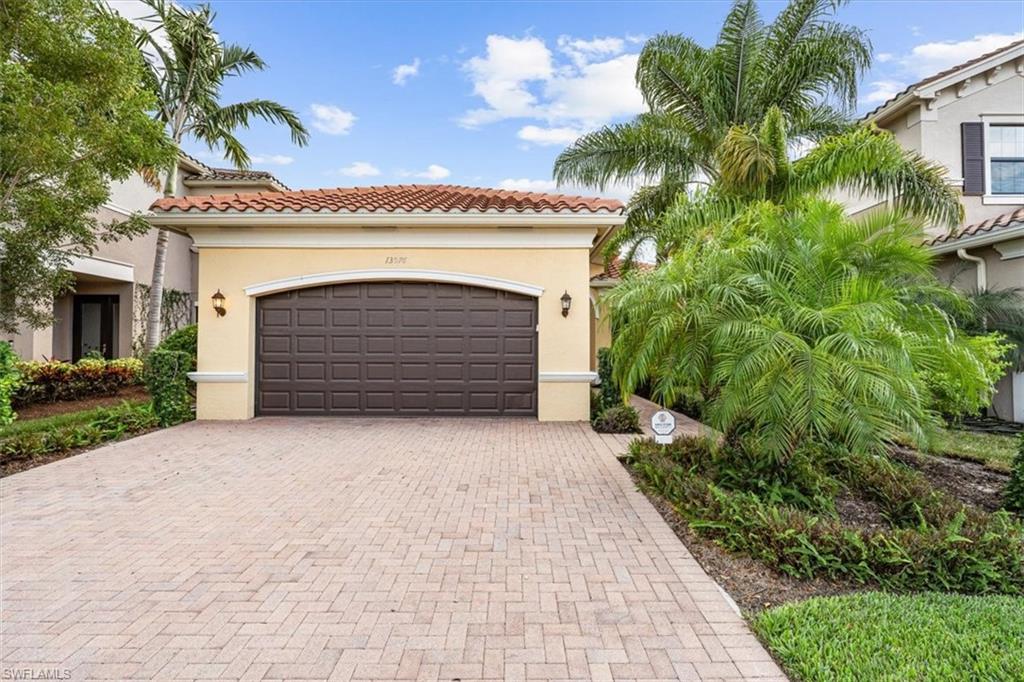 13576 Mandarin Circle Naples, FL 34109 - Photo 24 of 24 a front view of a house with a garden