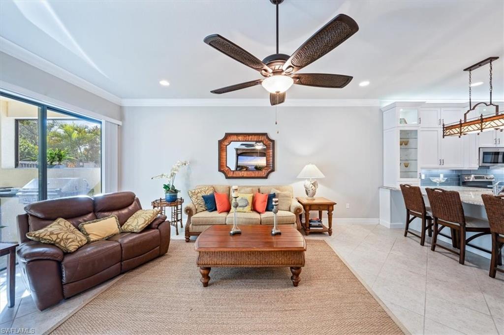 13576 Mandarin Circle Naples, FL 34109 - Photo 7 of 24 a living room with furniture and a large window