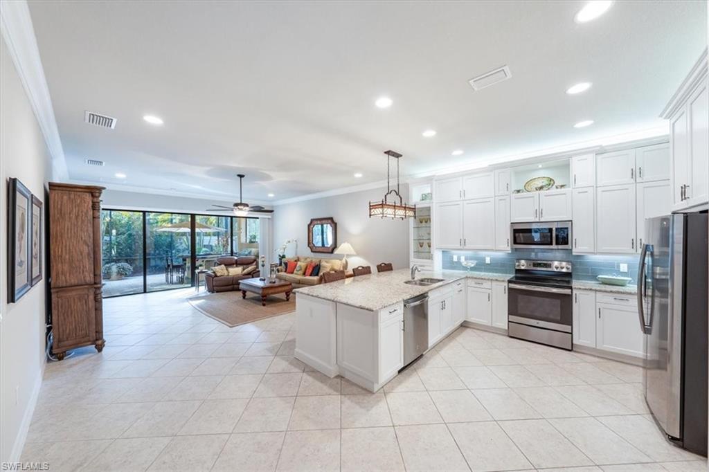 13576 Mandarin Circle Naples, FL 34109 - Photo 8 of 24 a view of kitchen with sink and stainless steel appliances