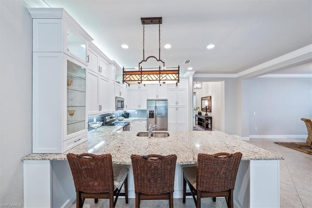 13576 Mandarin Circle Naples, FL 34109 - Photo 9 of 24 a view of a dining room with furniture