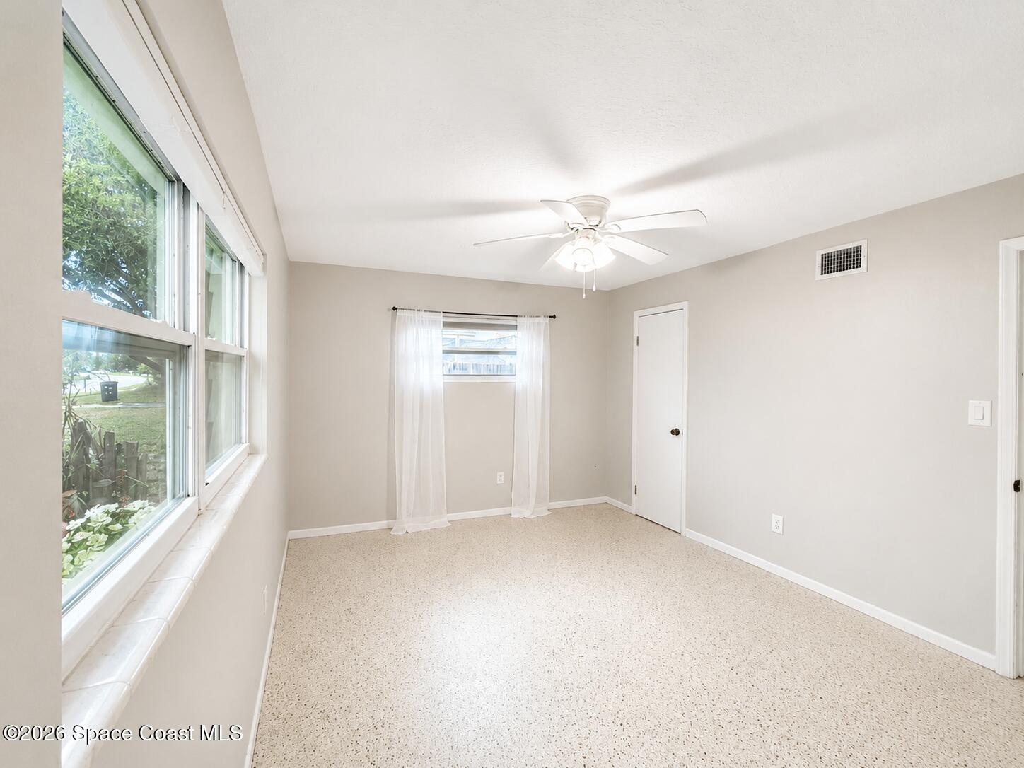 987 Kings Post Road Rockledge, FL 32955 - Photo 13 of 30 a view of an empty room with a window
