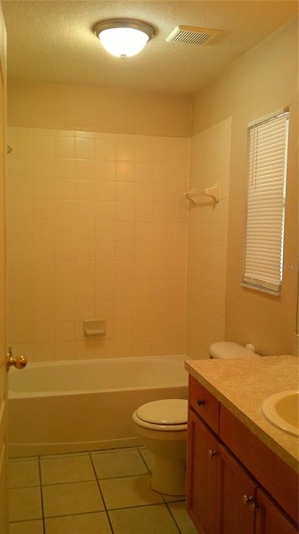 9724 Mary Robin Drive Riverview, FL 33569 - Photo 14 of 20 a bathroom with a granite countertop sink a toilet and a mirror