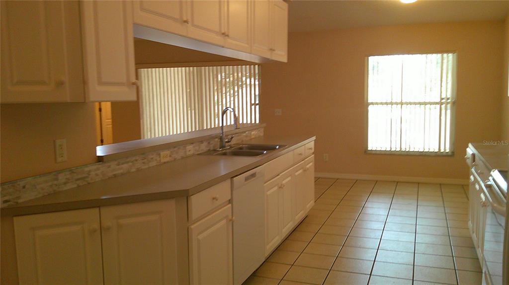 9724 Mary Robin Drive Riverview, FL 33569 - Photo 9 of 20 a bathroom with a granite countertop sink a toilet and a mirror