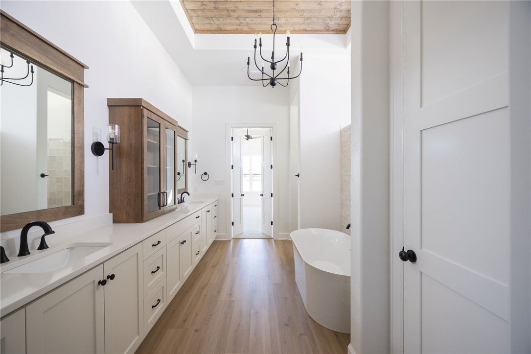 4760 Coral River Road College Station, TX 77845 - Photo 16 of 34 a bathroom with a granite countertop sink a toilet a shower and a mirror