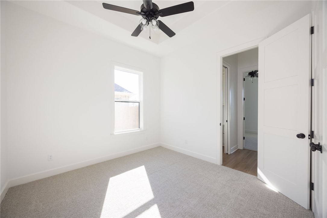 4760 Coral River Road College Station, TX 77845 - Photo 23 of 34 a view of a room with a window and a ceiling fan