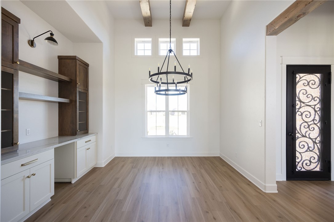 4760 Coral River Road College Station, TX 77845 - Photo 4 of 34 a view of an empty room with wooden floor and a window
