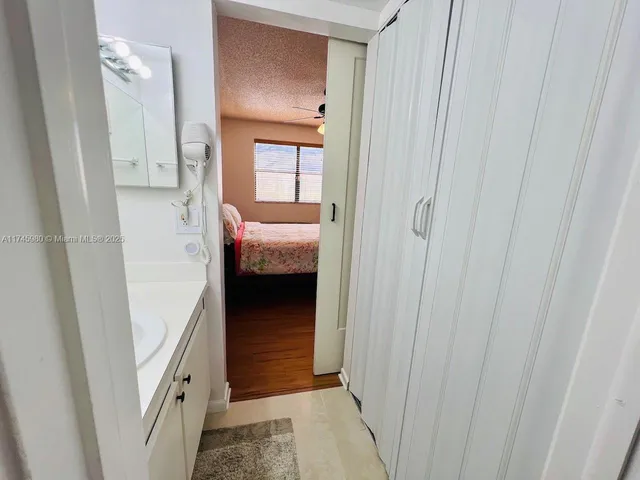 a view of a hallway and a livingroom and a bathroom