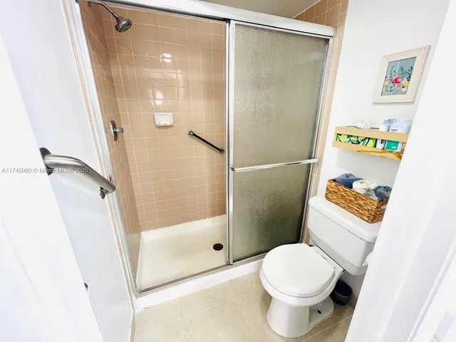 a bathroom with a shower and a toilet