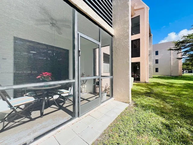 a view of a patio with table and chairs and potted plants