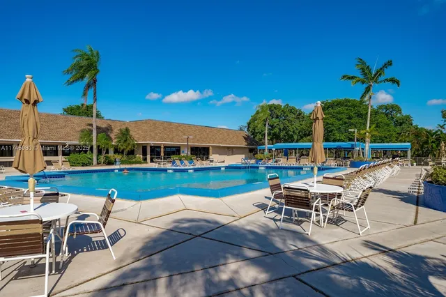 a swimming pool with outdoor seating and yard