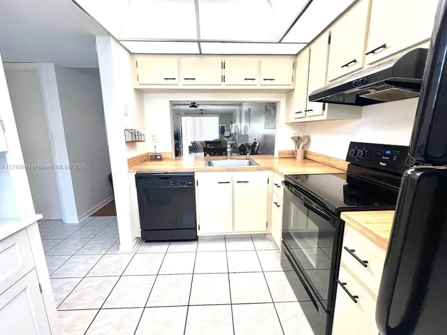 a kitchen with a sink a stove and a refrigerator