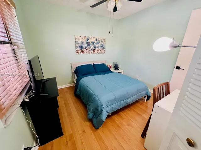 a bedroom with two beds and painting on the wall