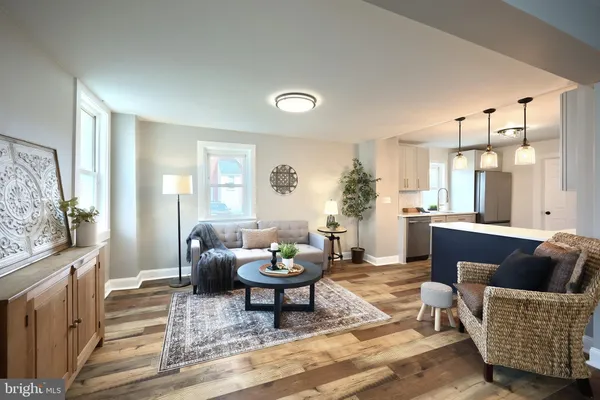 a living room with furniture and a potted plant