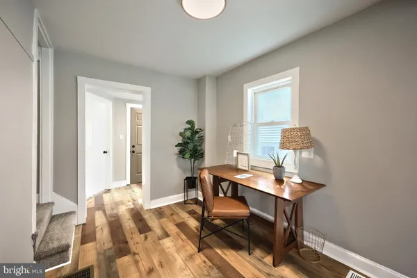 a dining room with furniture and wooden floor