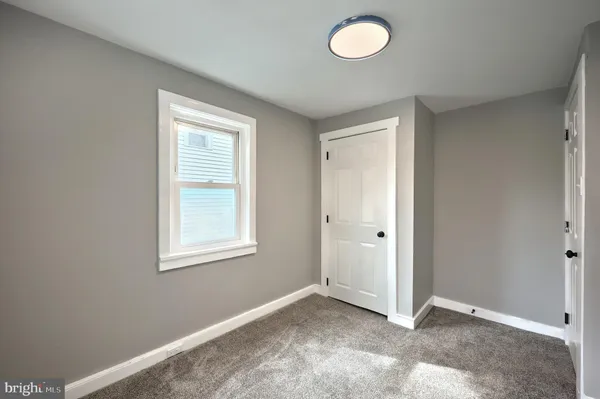 an empty room with windows and window