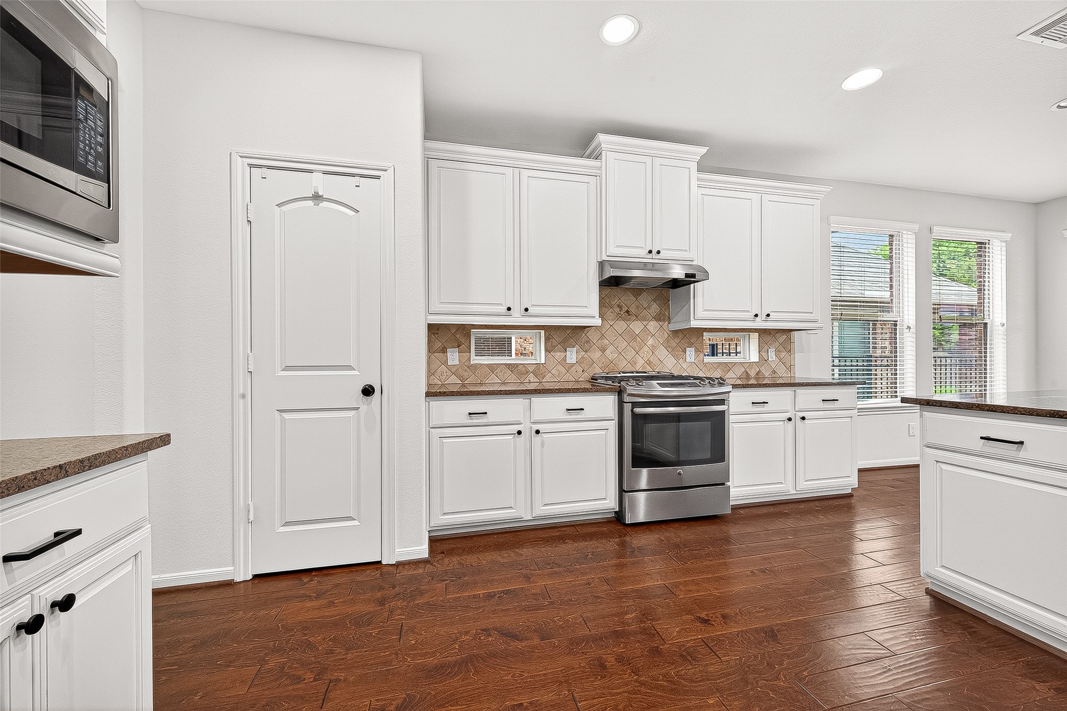 138 South Sawbridge Circle Spring, TX 77389 - Photo 18 of 37 a kitchen with granite countertop white cabinets and white appliances
