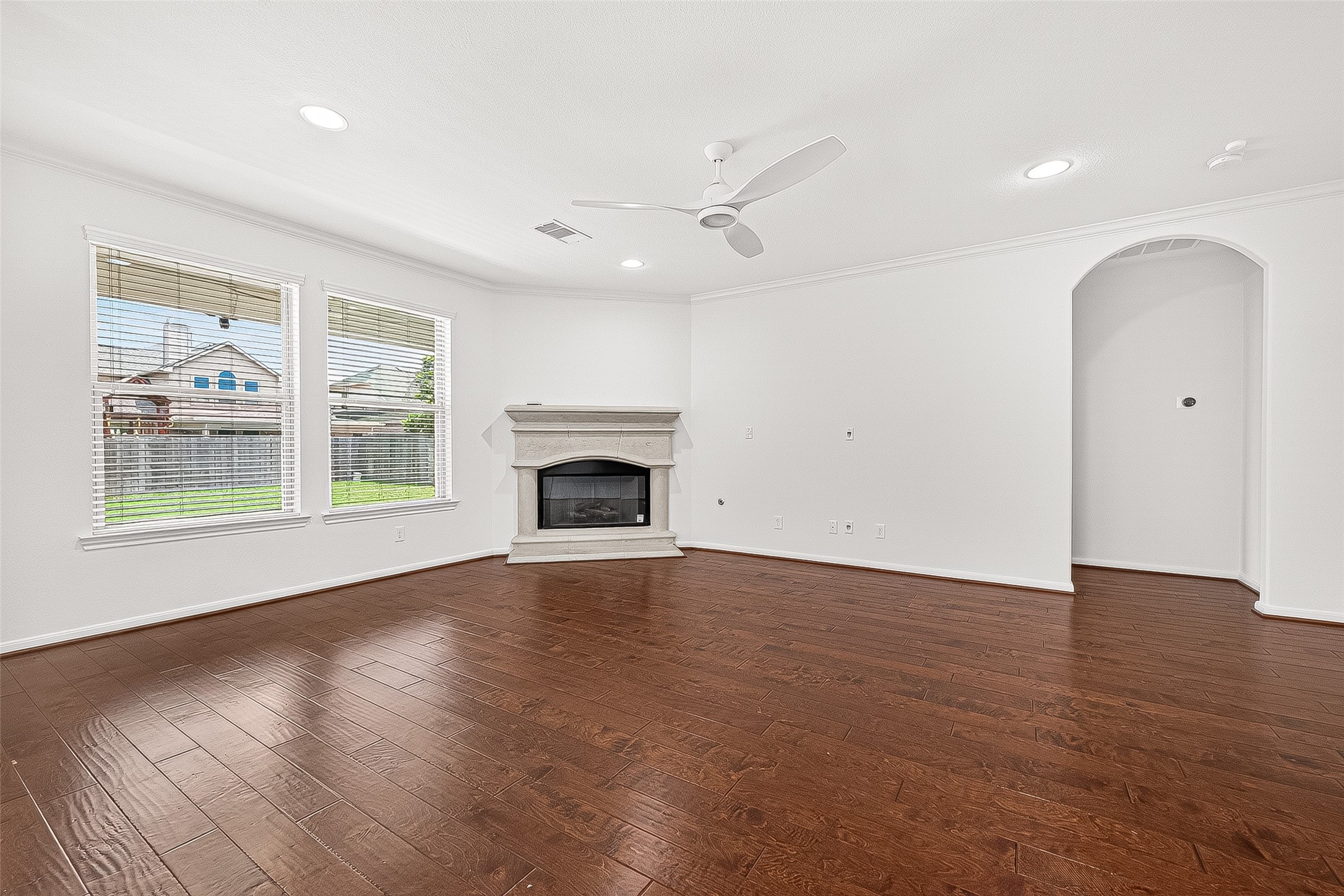 138 South Sawbridge Circle Spring, TX 77389 - Photo 10 of 37 an empty room with wooden floor a ceiling fan and windows