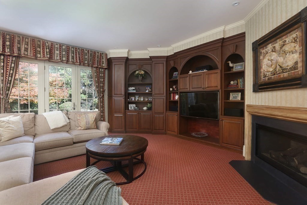 177 Bridle Trail Road Needham, MA 02492 - Photo 13 of 41 a living room with furniture a flat screen tv and a fireplace